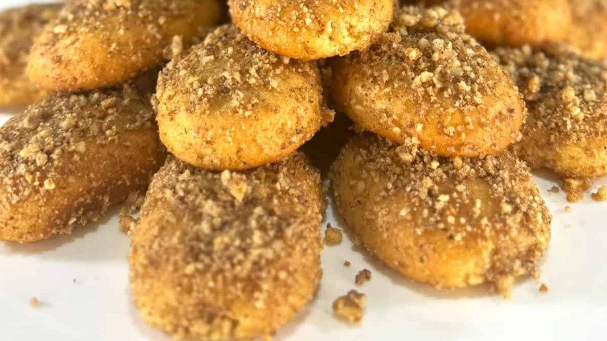 Traditional Greek Melomakarona biscuits topped with walnuts